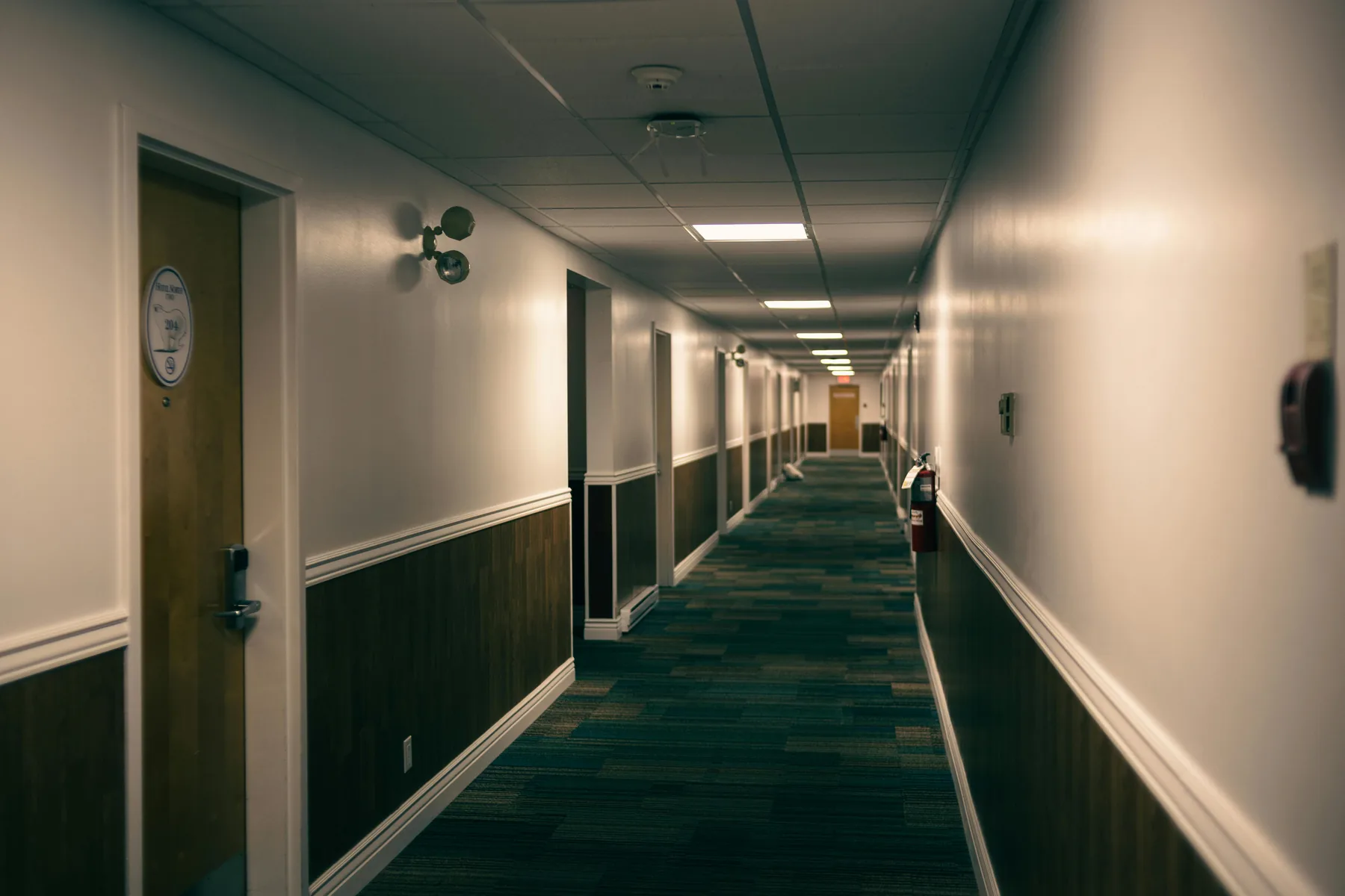 Quiet hotel corridor with guest room doors